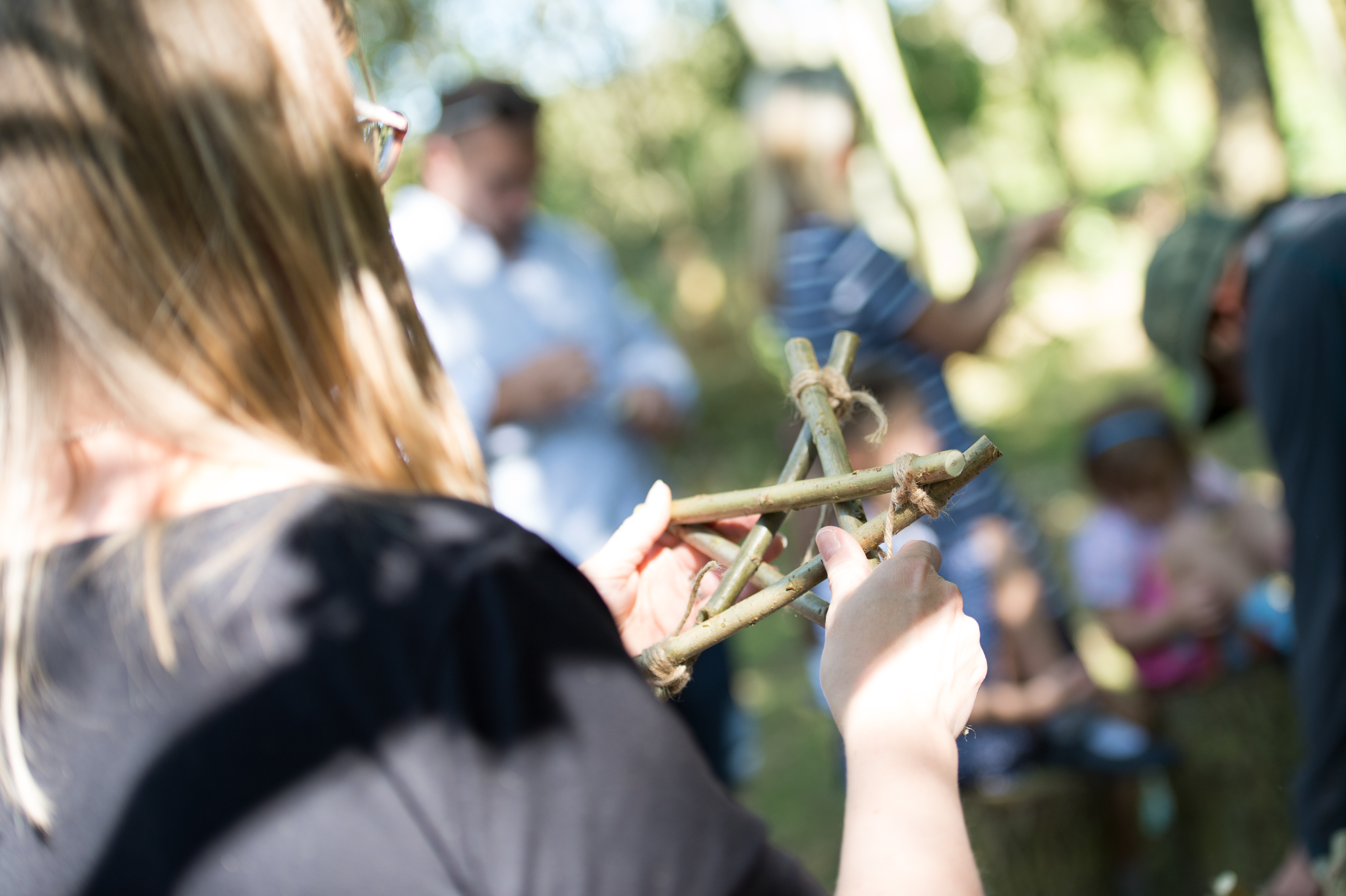 Visitor holds a star made of small twigs