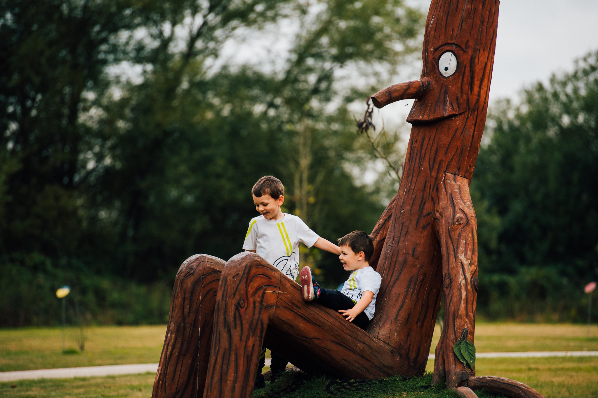 Children sitting on Stick Man at the Arboretum