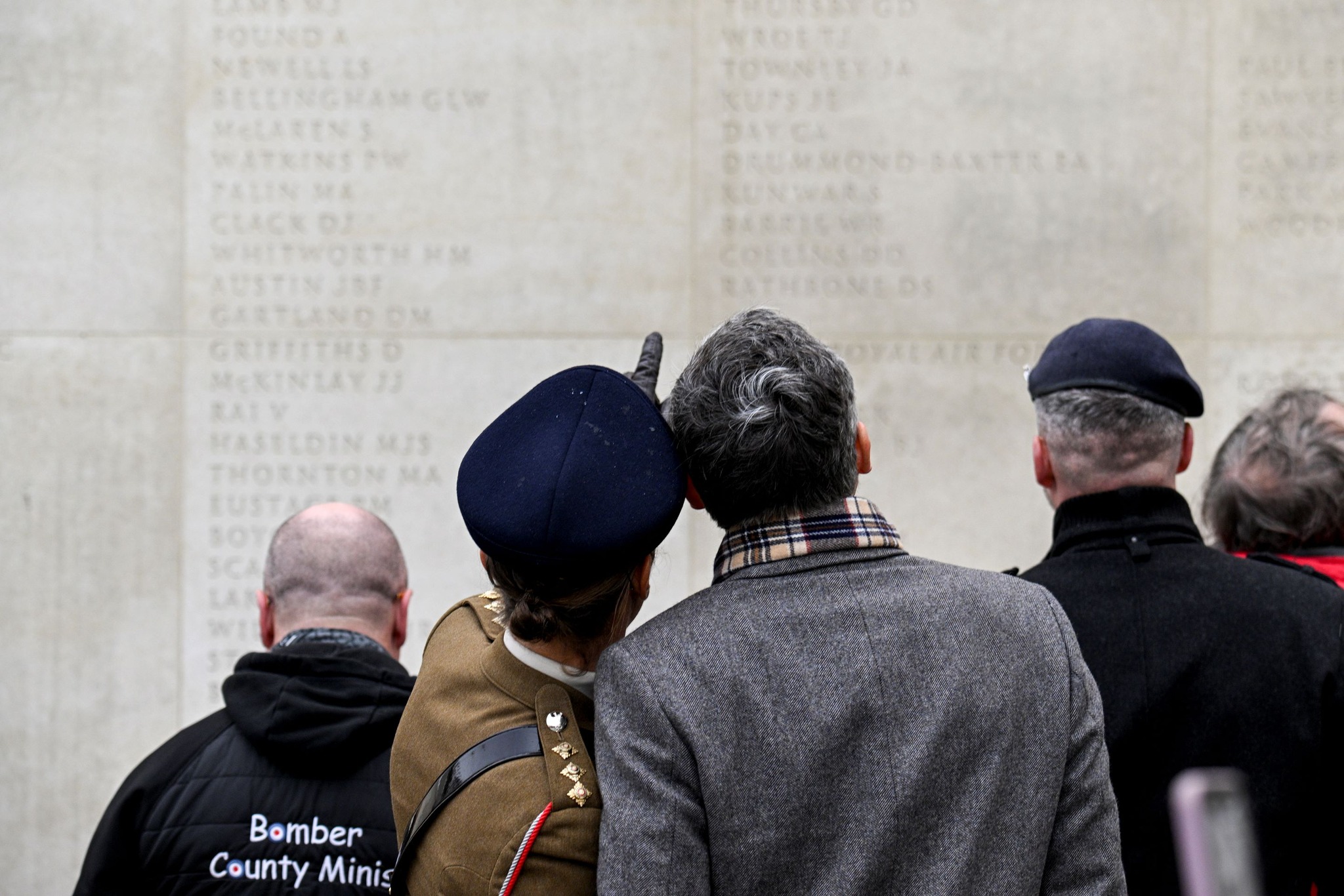 Visitors looking at names on the Armed Forces Memorial