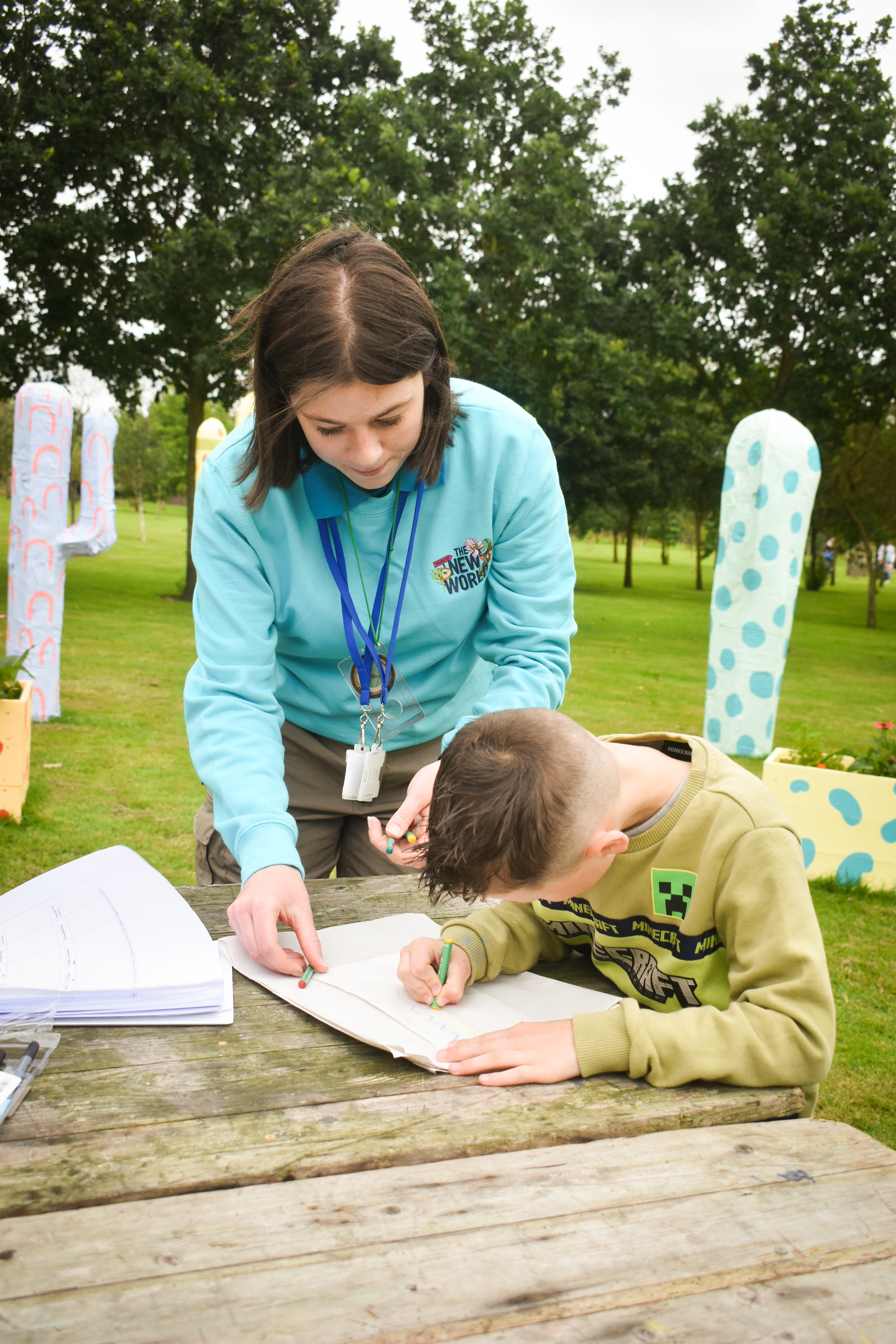 A young boy writes on a piece of paper