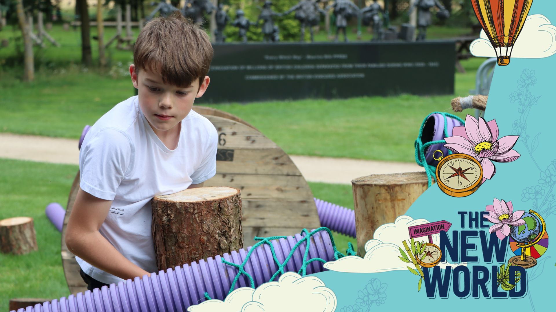A young boy adds a large log to a playscape that he has created