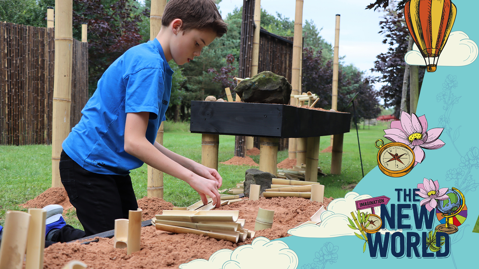 Image shows young boy playing with bamboo structure