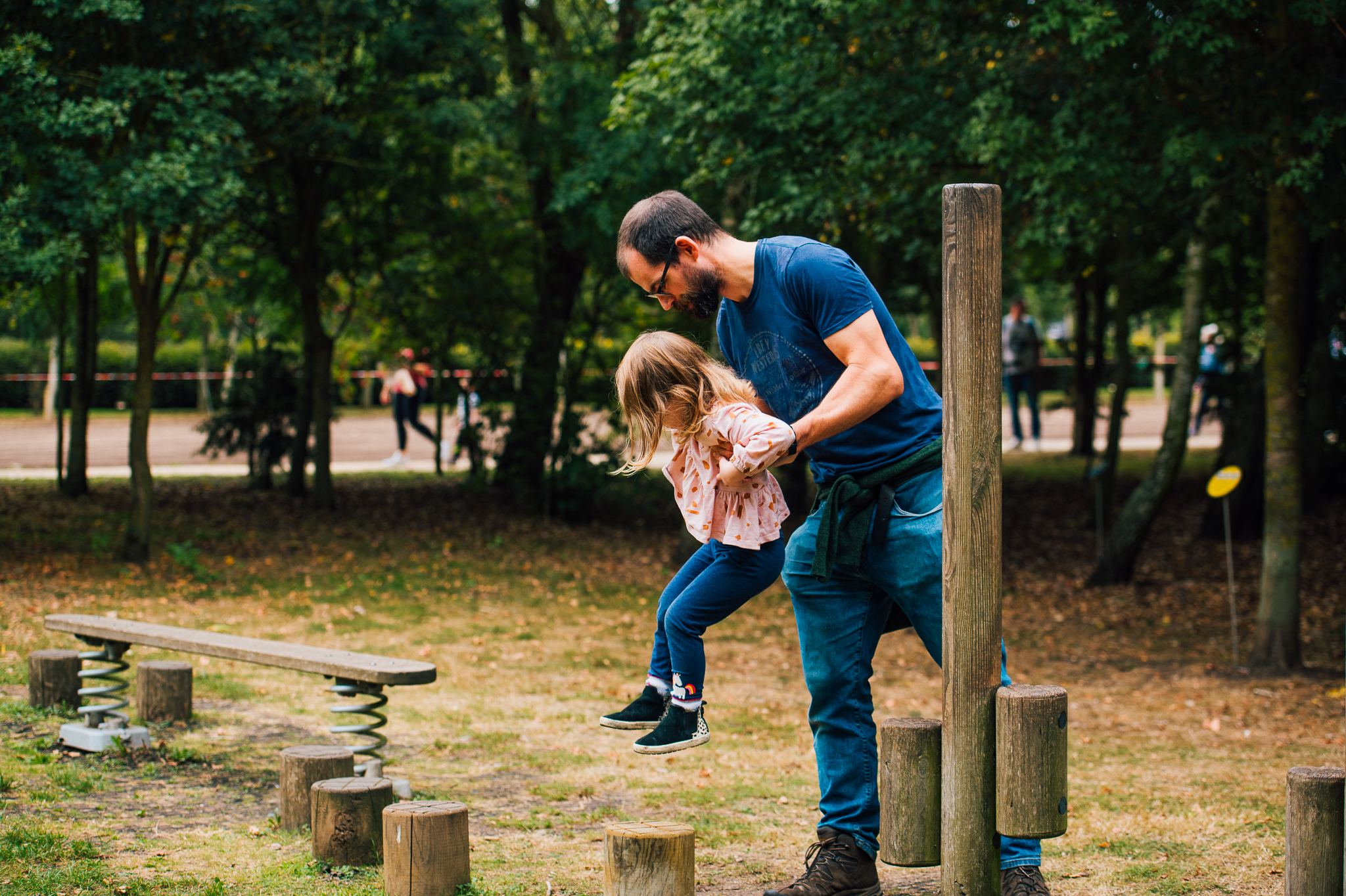 A family playing in the outdoor play area