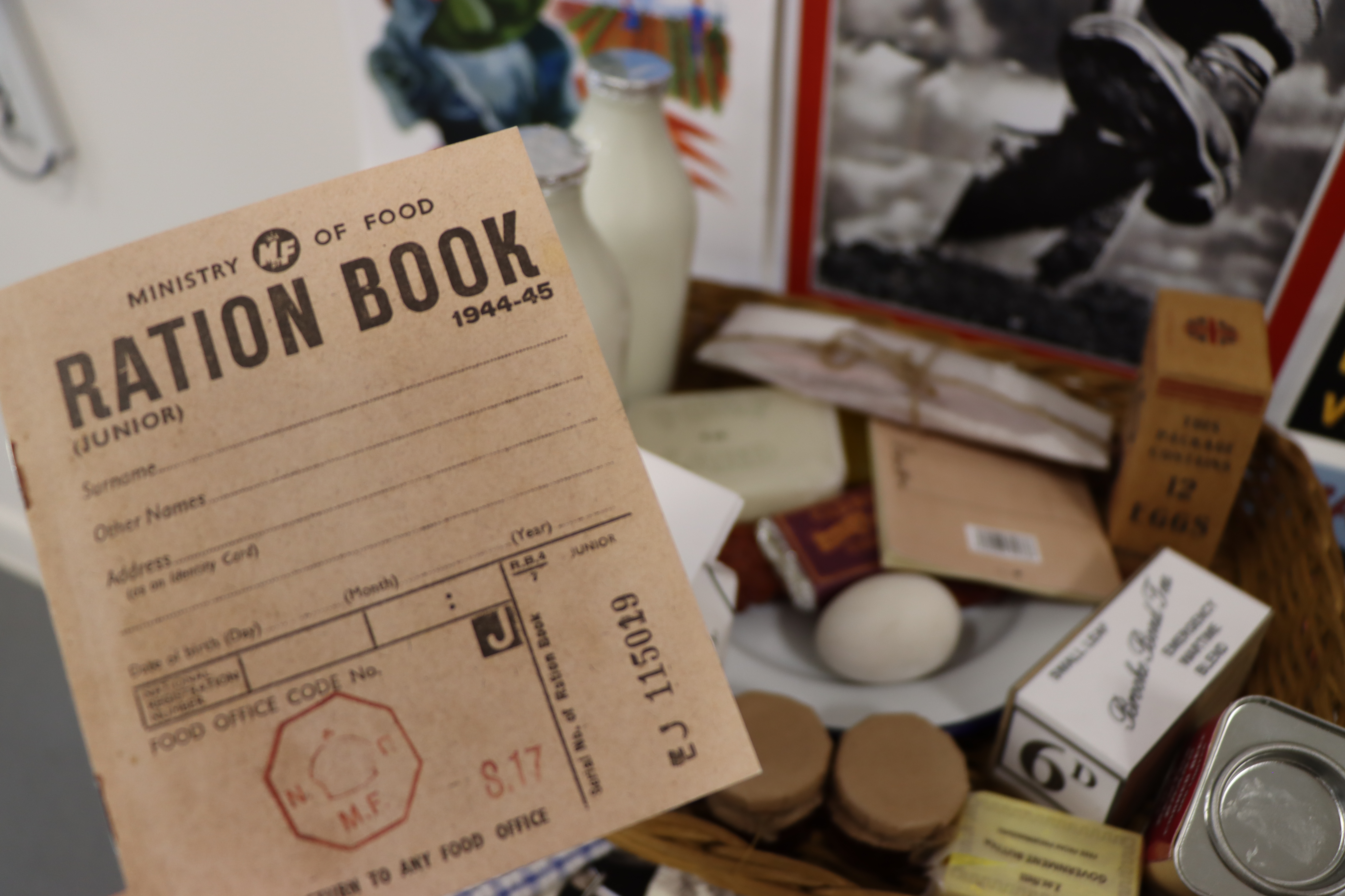 Image featuring a ration book and examples of food from 1944