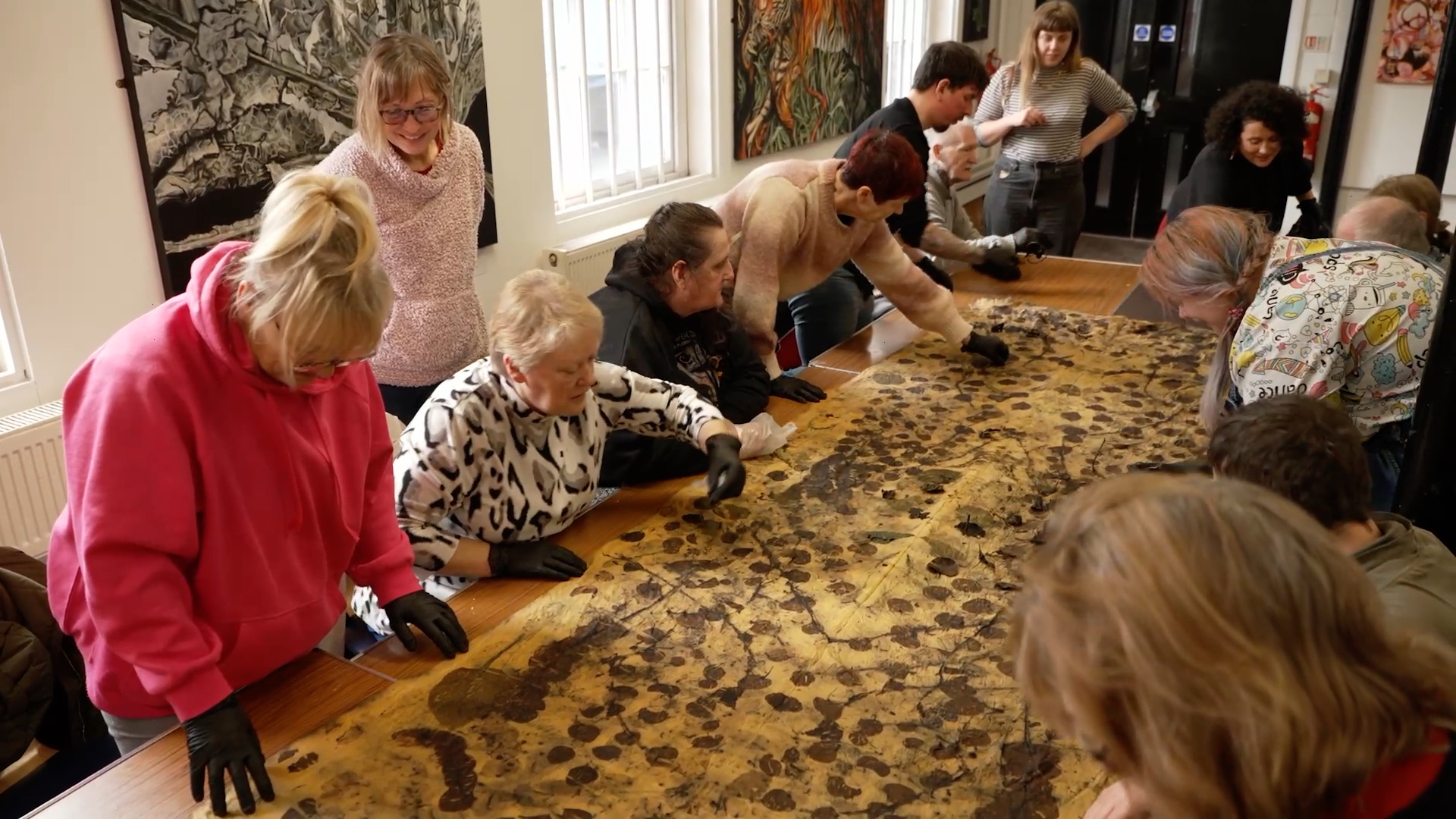 Participants from a Burton social prescribing group eco-dye their silk hangings