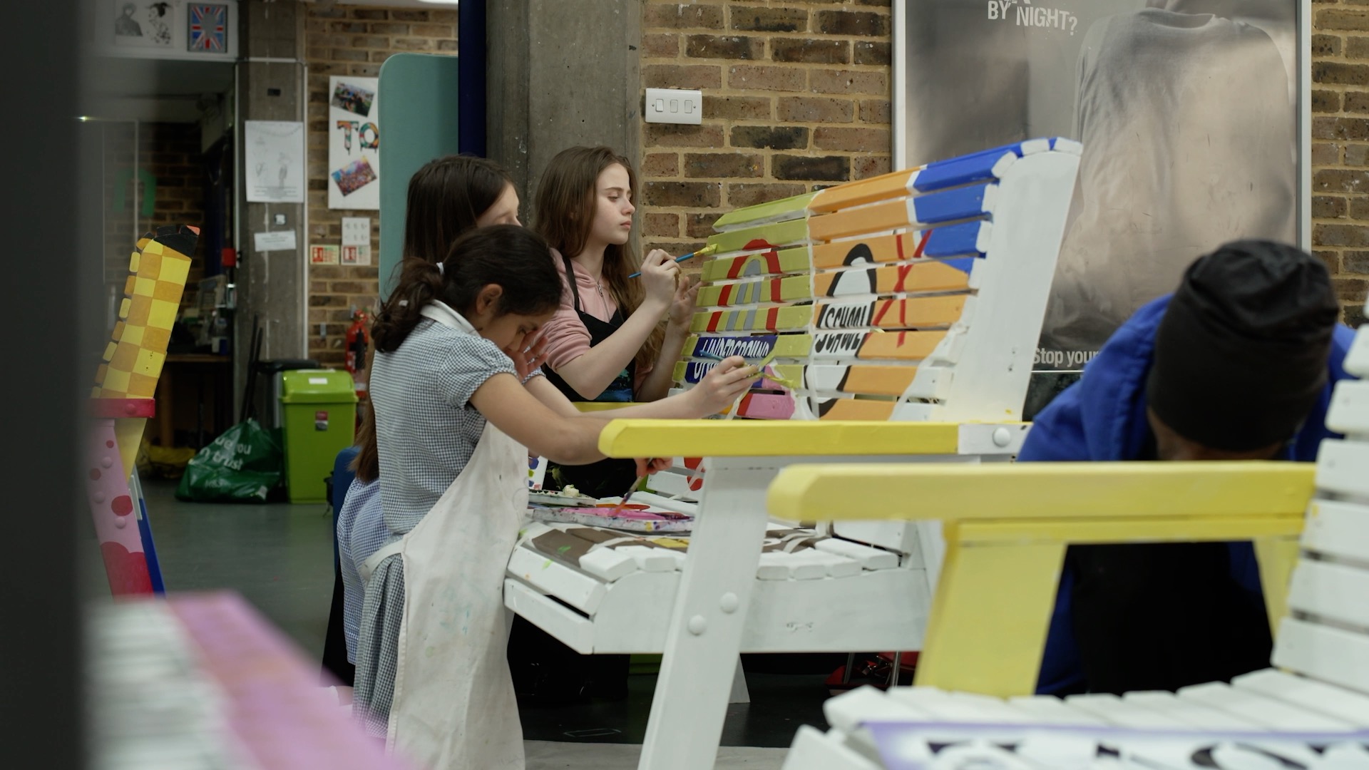 Young people from Westminster decorate benches at St Andrew's Youth Club