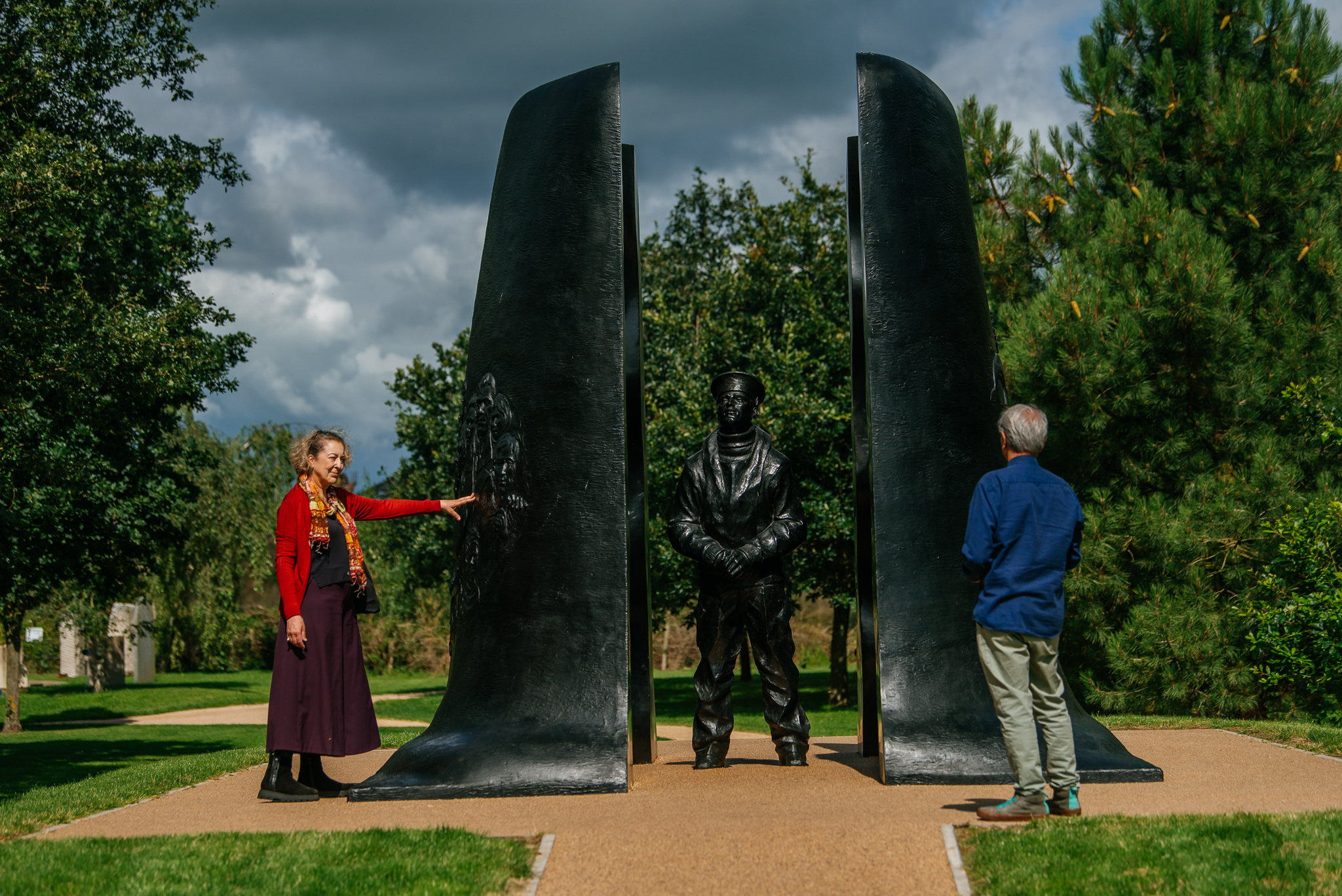 A group of people looking at the Submariners Memorial