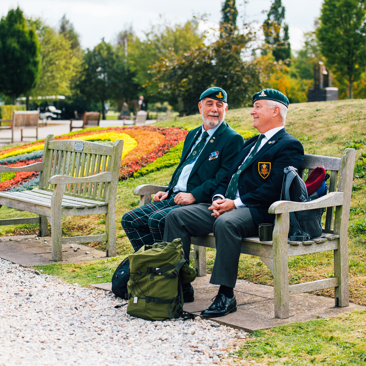 Veterans sitting on a bench at the National Memorial Arboretum